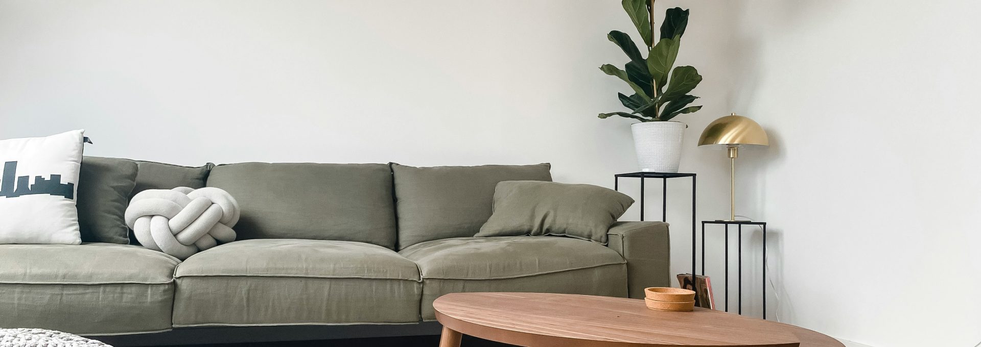 gray 2 seat sofa near brown wooden coffee table